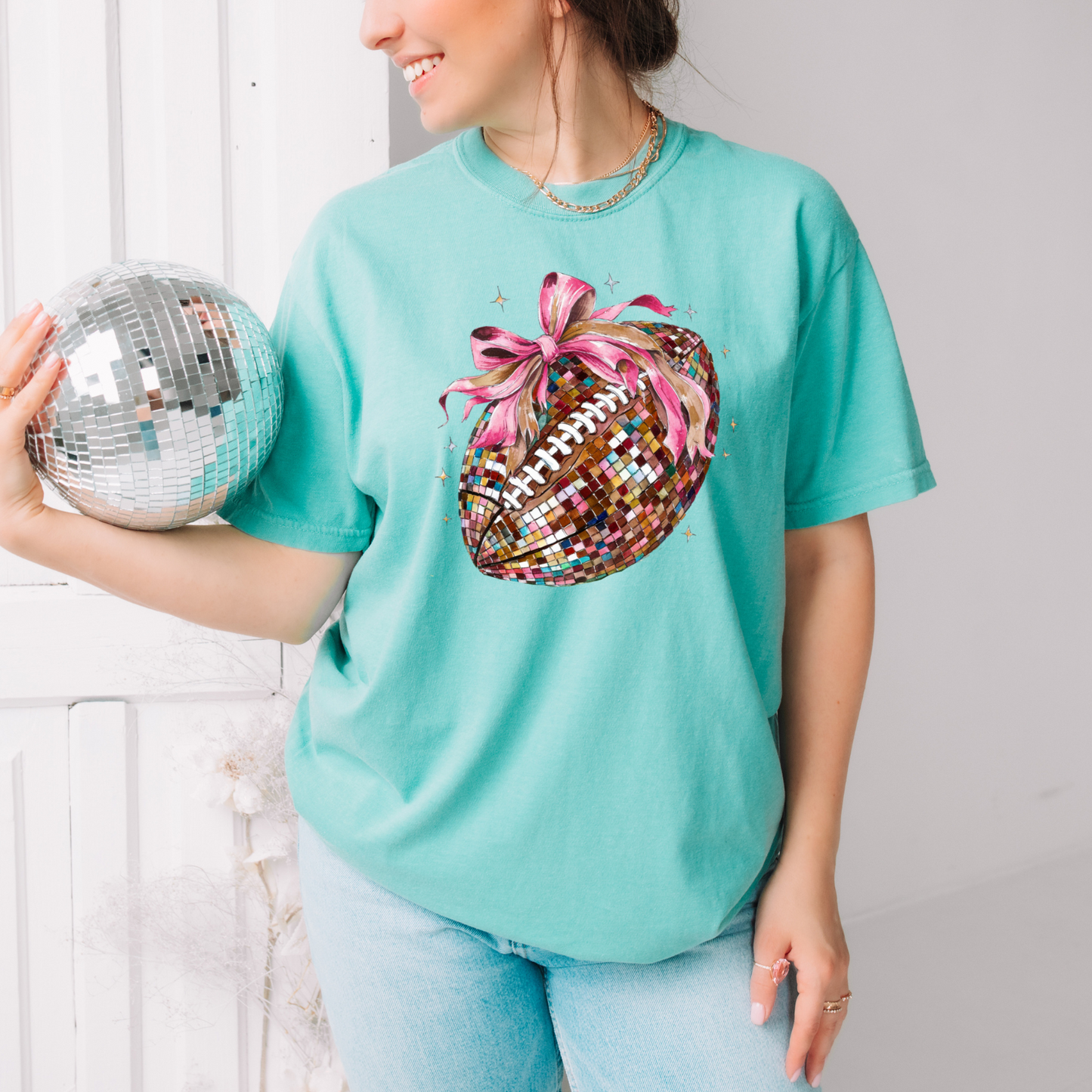 a woman holding a disco ball in her hands