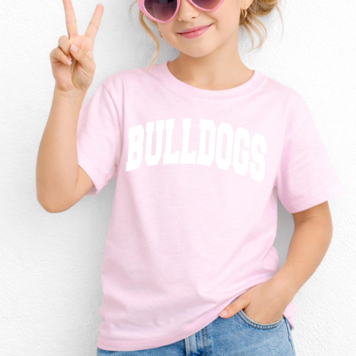 Light Pink Gildan 5000B youth tee with white collegiate Bulldogs wordmark