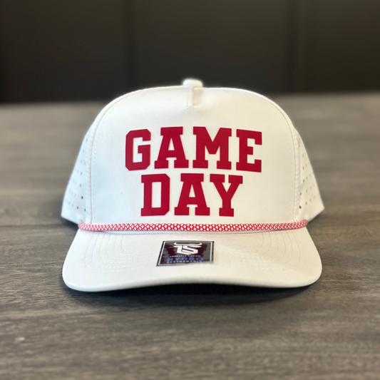 A white baseball cap with the text "GAME DAY" printed on it.