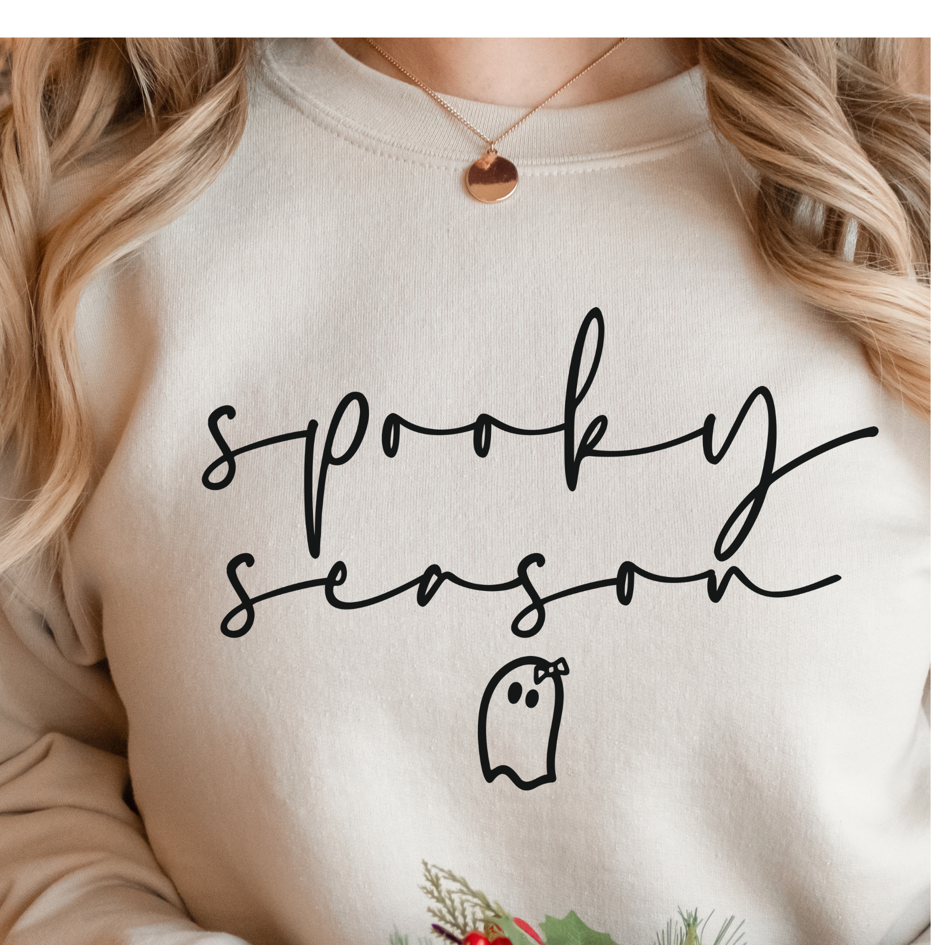 a woman wearing a sweatshirt that says spooky season