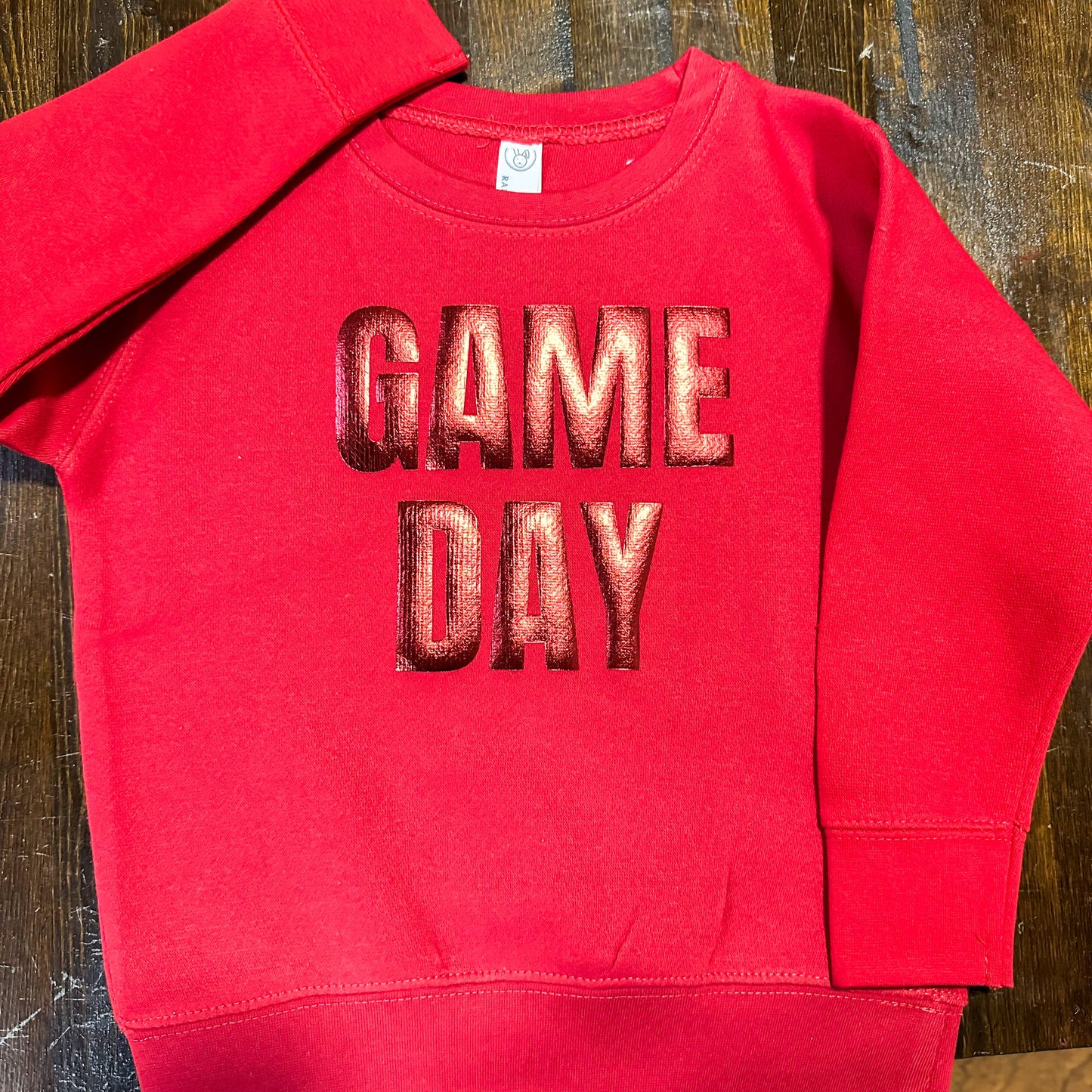 A red sweatshirt with the text "GAME DAY" printed on it.