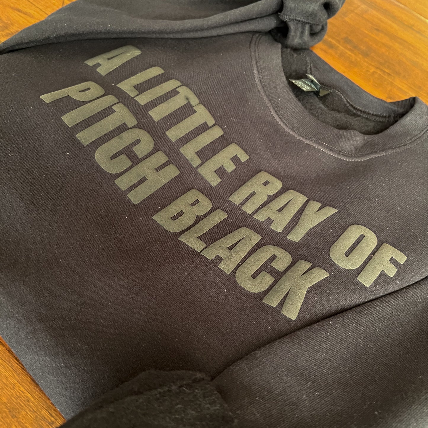 A Little Ray of Pitch Black Sweatshirt