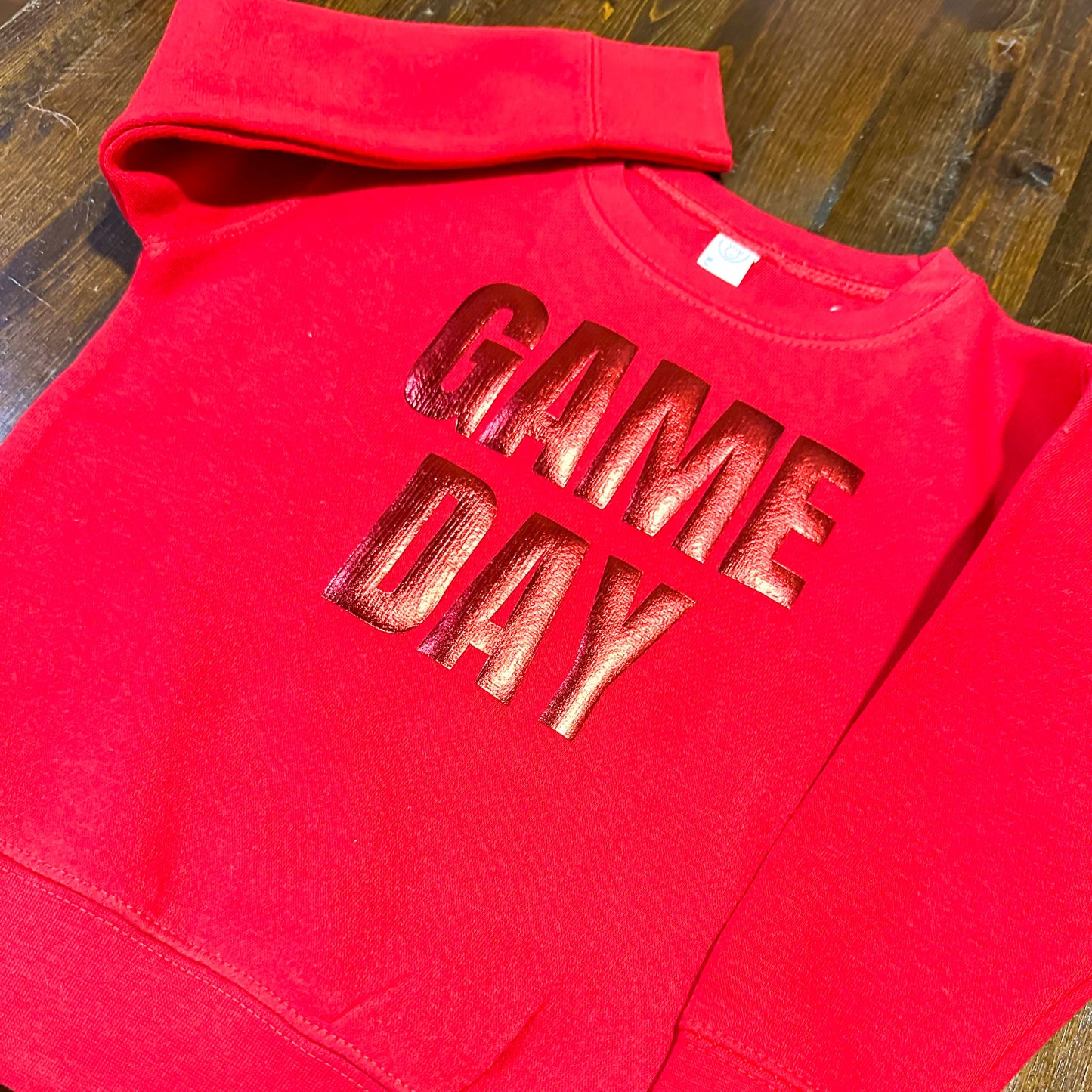 A red sweatshirt with the text "GAME DAY" printed on it.