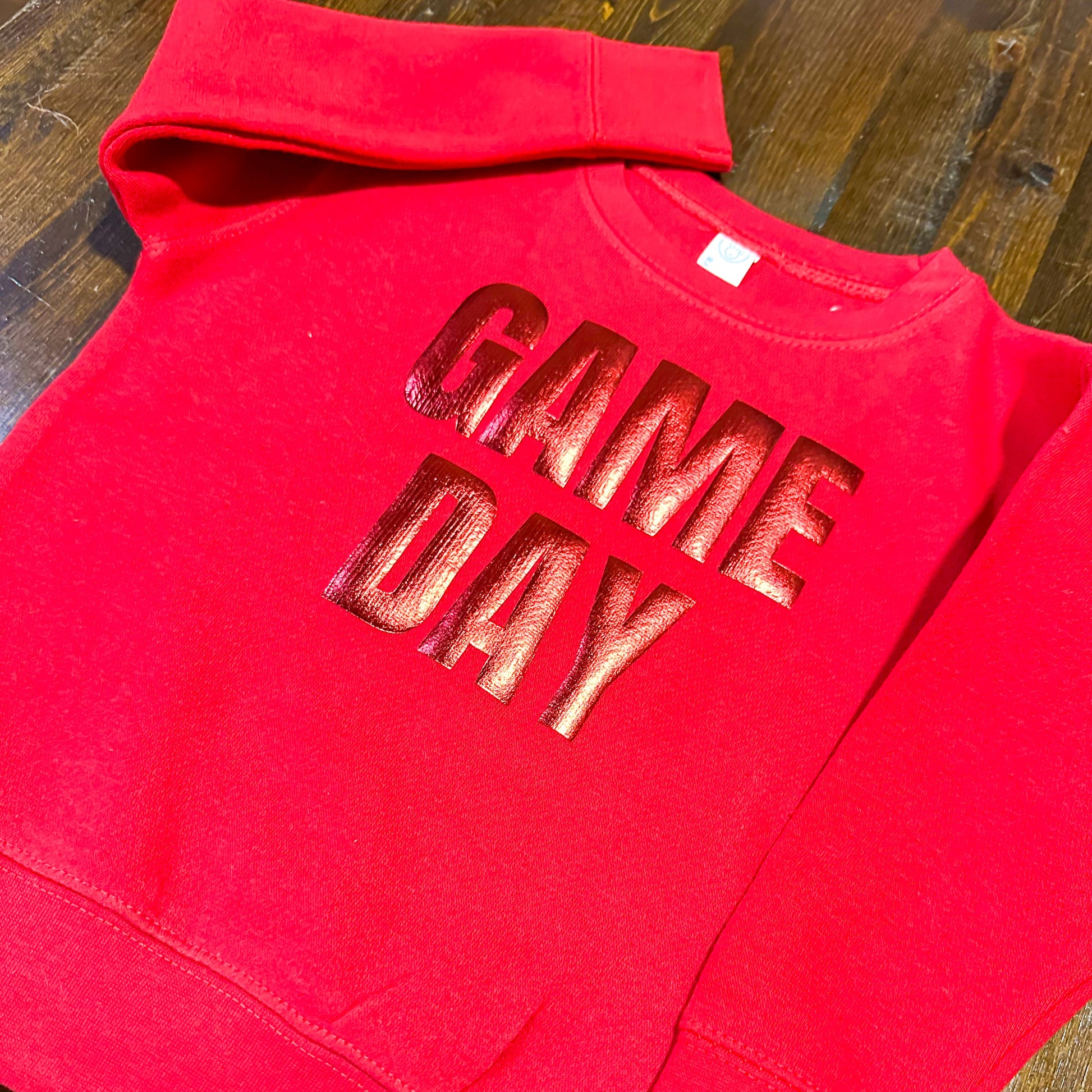 A red sweatshirt with the text "GAME DAY" printed on it.