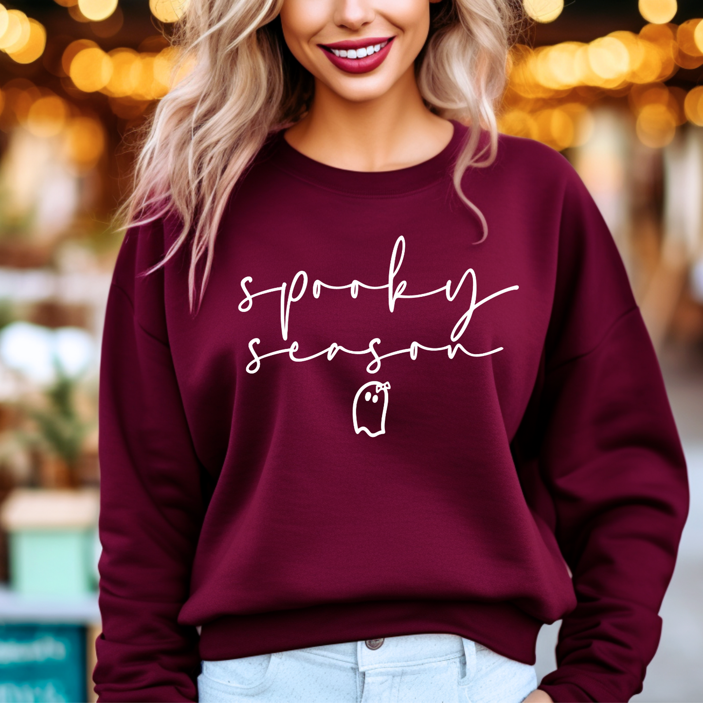 a woman with blonde hair wearing a burgundy sweatshirt