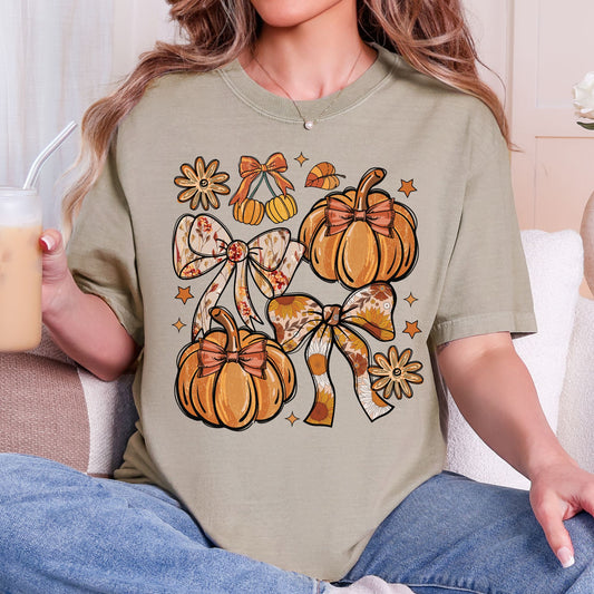 Orange pumpkins, floral bows, daisies, and stars on a Khaki T-shirt