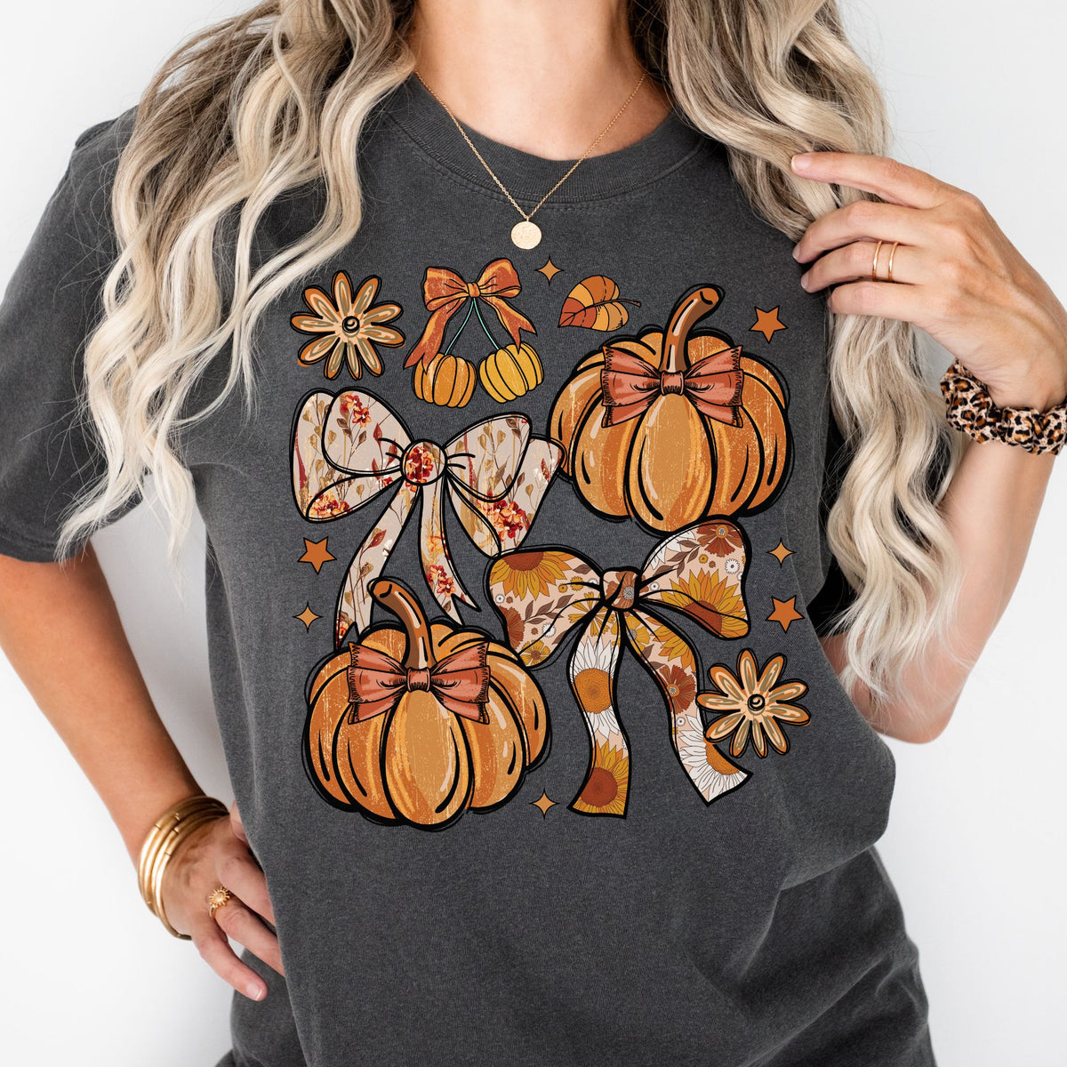 Orange pumpkins, floral bows, daisies, and stars on a Pepper T-shirt