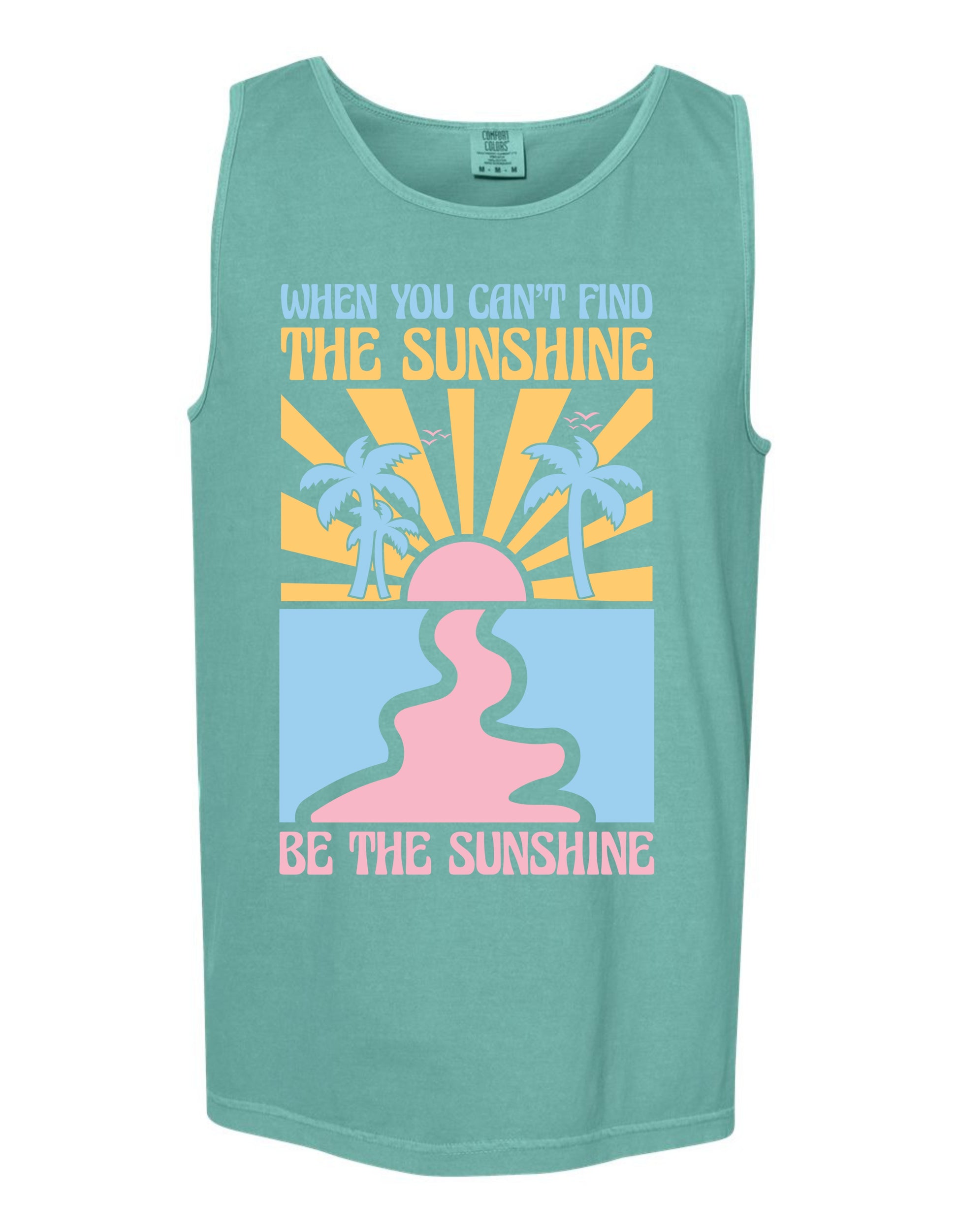 A green tank top with a graphic design featuring a sun and palm trees, along with the text "When you can't find the sunshine, be the sunshine" printed on it.