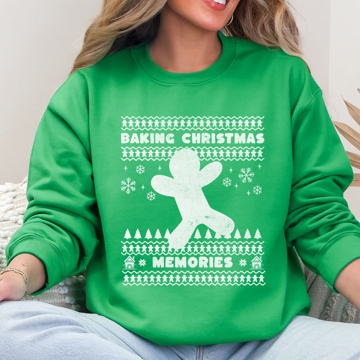 Woman wearing a green Baking Christmas Memories reindeer sweatshirt.