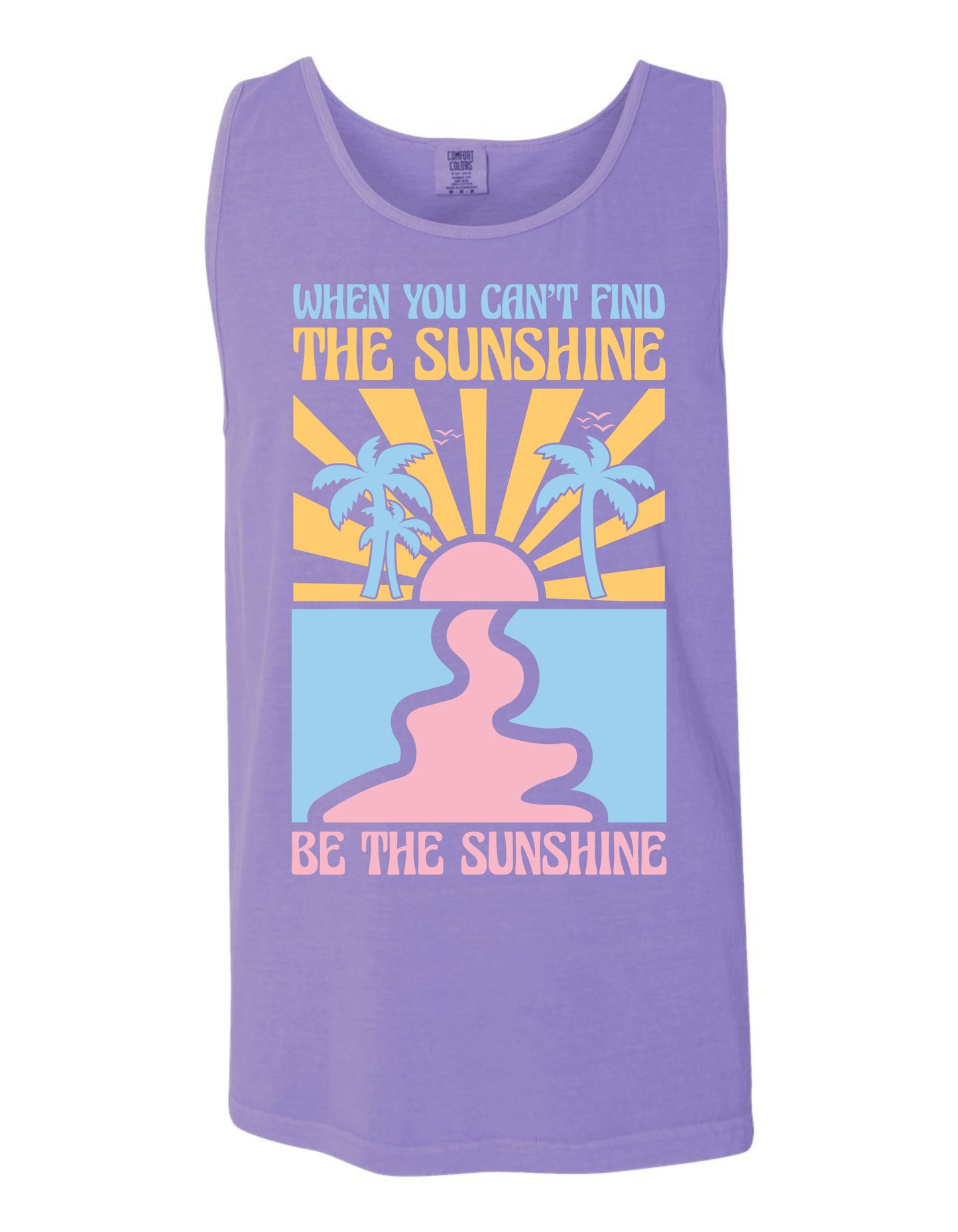 The image is a purple tank top with a graphic design featuring a sun and palm trees, along with the text "When you can't find the sunshine, be the sunshine" printed on it.