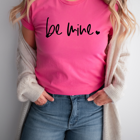 Woman wearing a Charity Pink Be Mine graphic T-shirt
