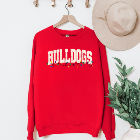 Red Gildan 18000 Bulldogs Christmas lights sweatshirt hanging on a wooden hanger