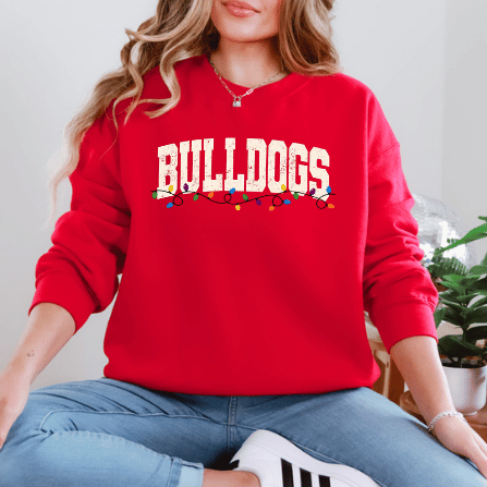 Model wearing a red Gildan 18000 Bulldogs Christmas lights sweatshirt