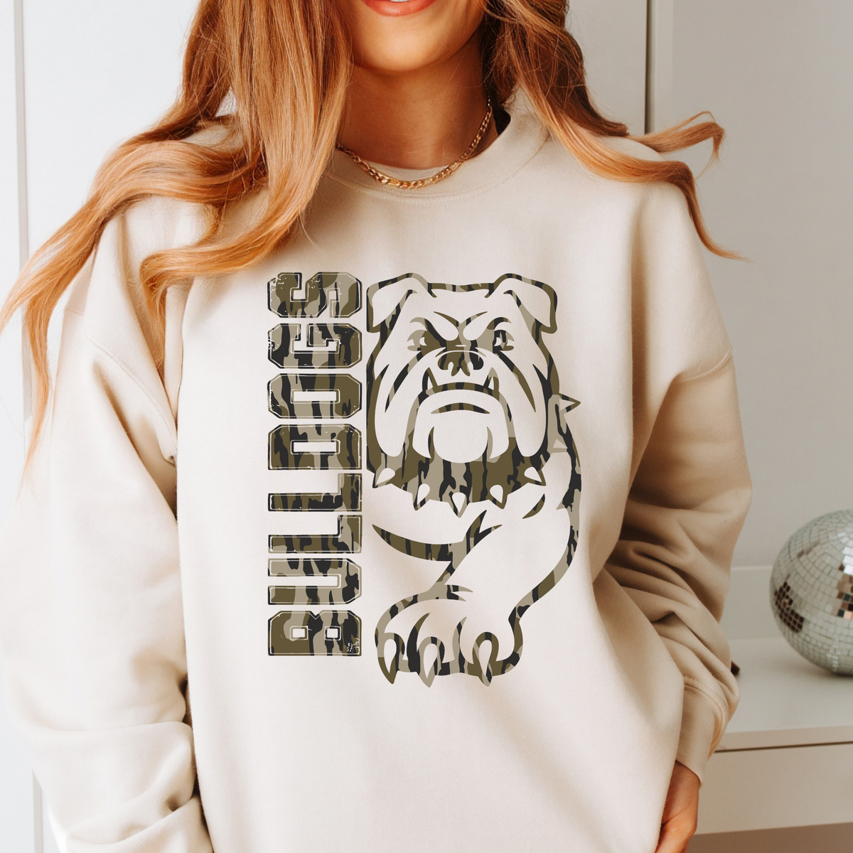 Woman wearing a Sand Camo Bulldogs full mascot sweatshirt