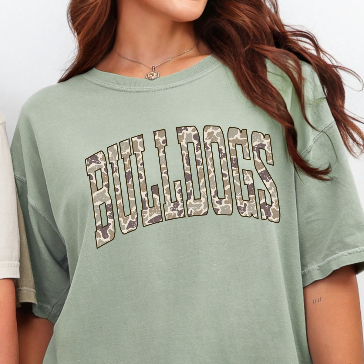 Woman wearing a Bay Camo BULLDOGS graphic T-shirt