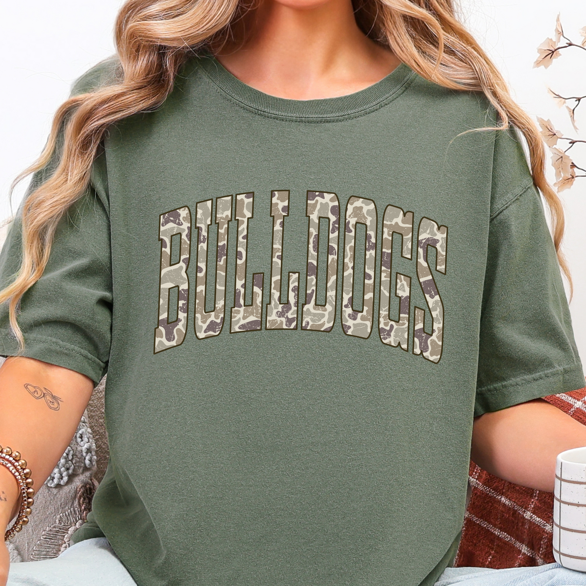 Woman wearing a Moss Camo BULLDOGS graphic T-shirt