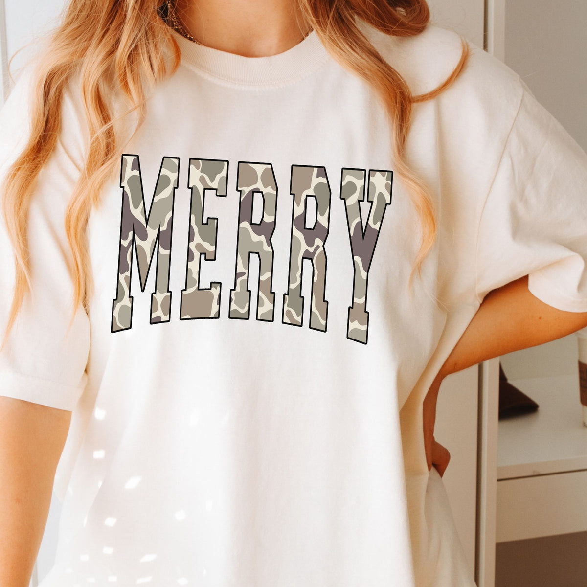 Camo MERRY varsity lettering on a Ivory T-shirt