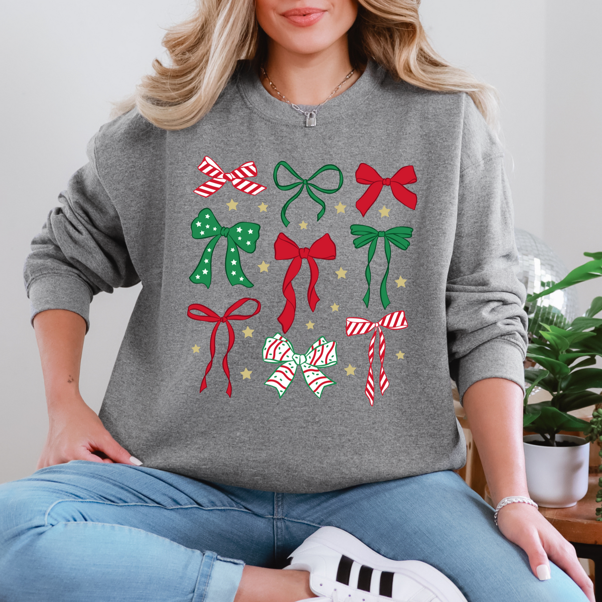 Christmas bow collage design on a graphite heather crewneck sweatshirt