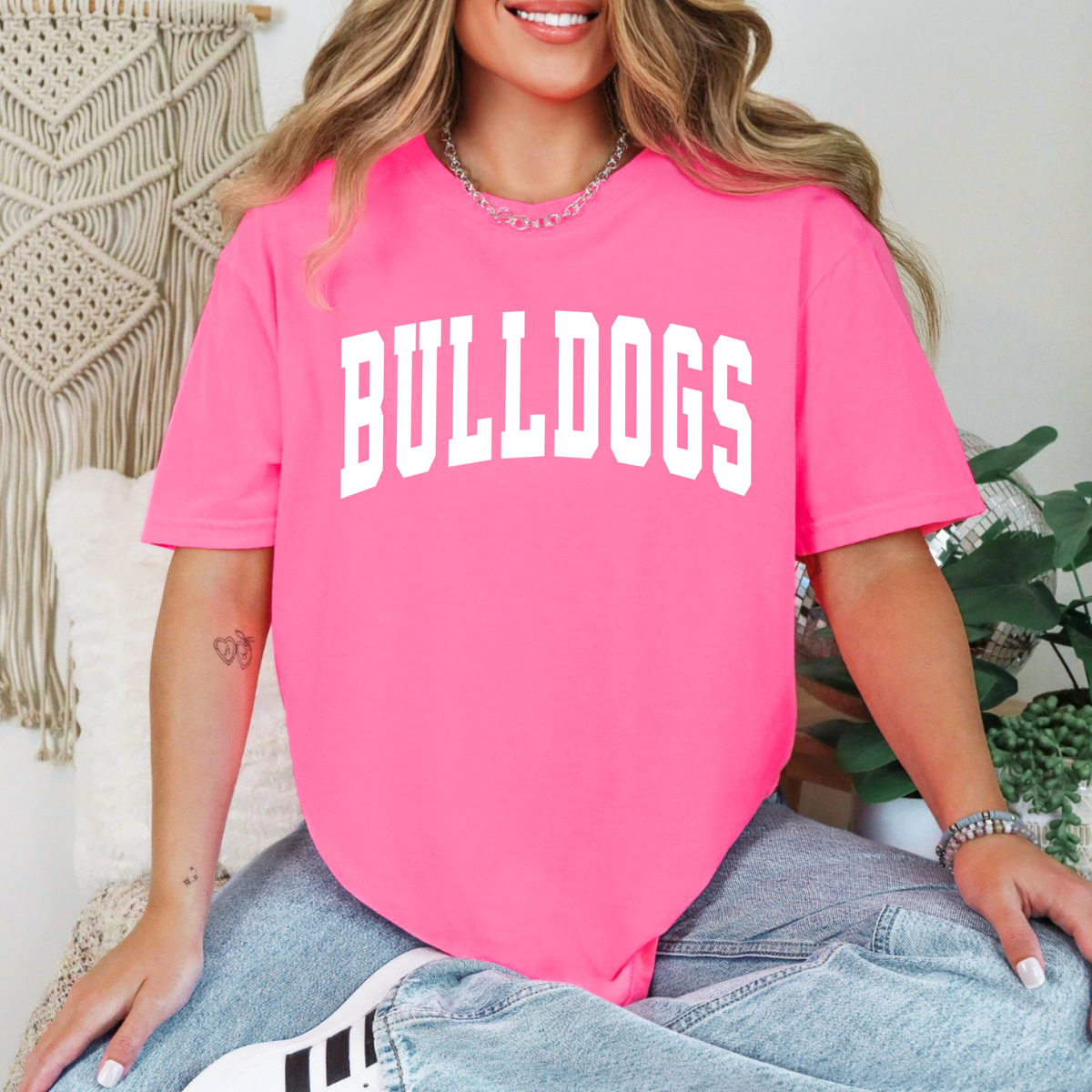 Woman wearing a Neon Pink Collegiate Bulldogs graphic T-shirt