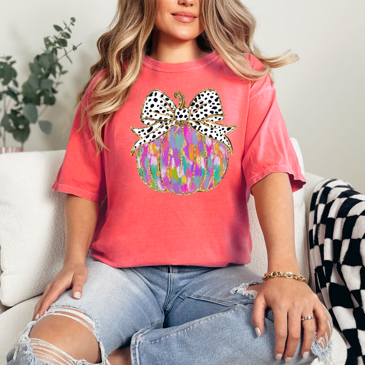 Colorful painted pumpkin with spotted bow on a Bright Salmon Comfort Colors 1717 T-shirt