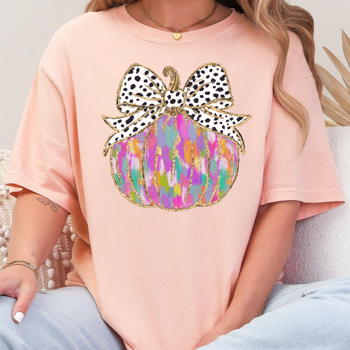 Colorful painted pumpkin with spotted bow on a Peachy Comfort Colors 1717 T-shirt