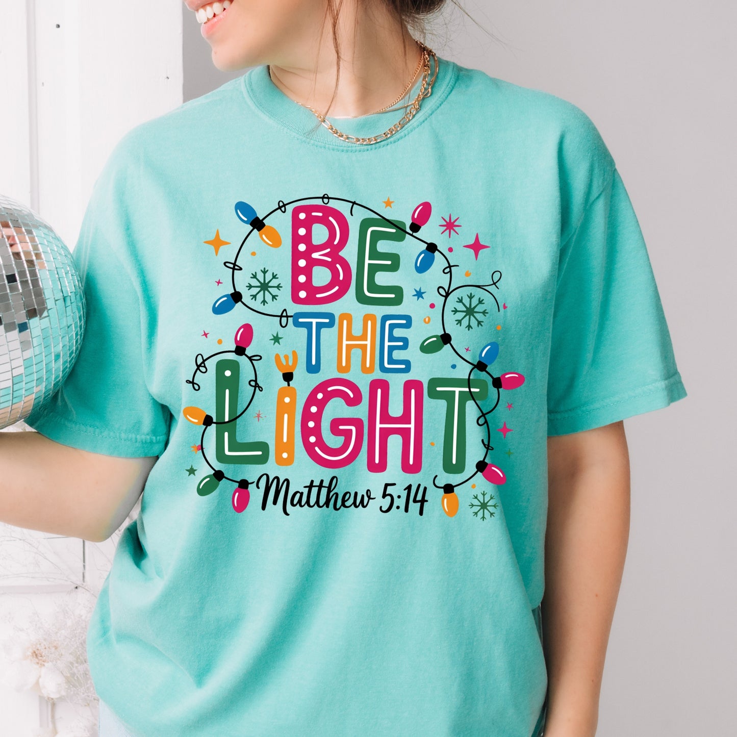 Be The Light – Matthew 5:14 Christmas Lights Comfort Colors Tee