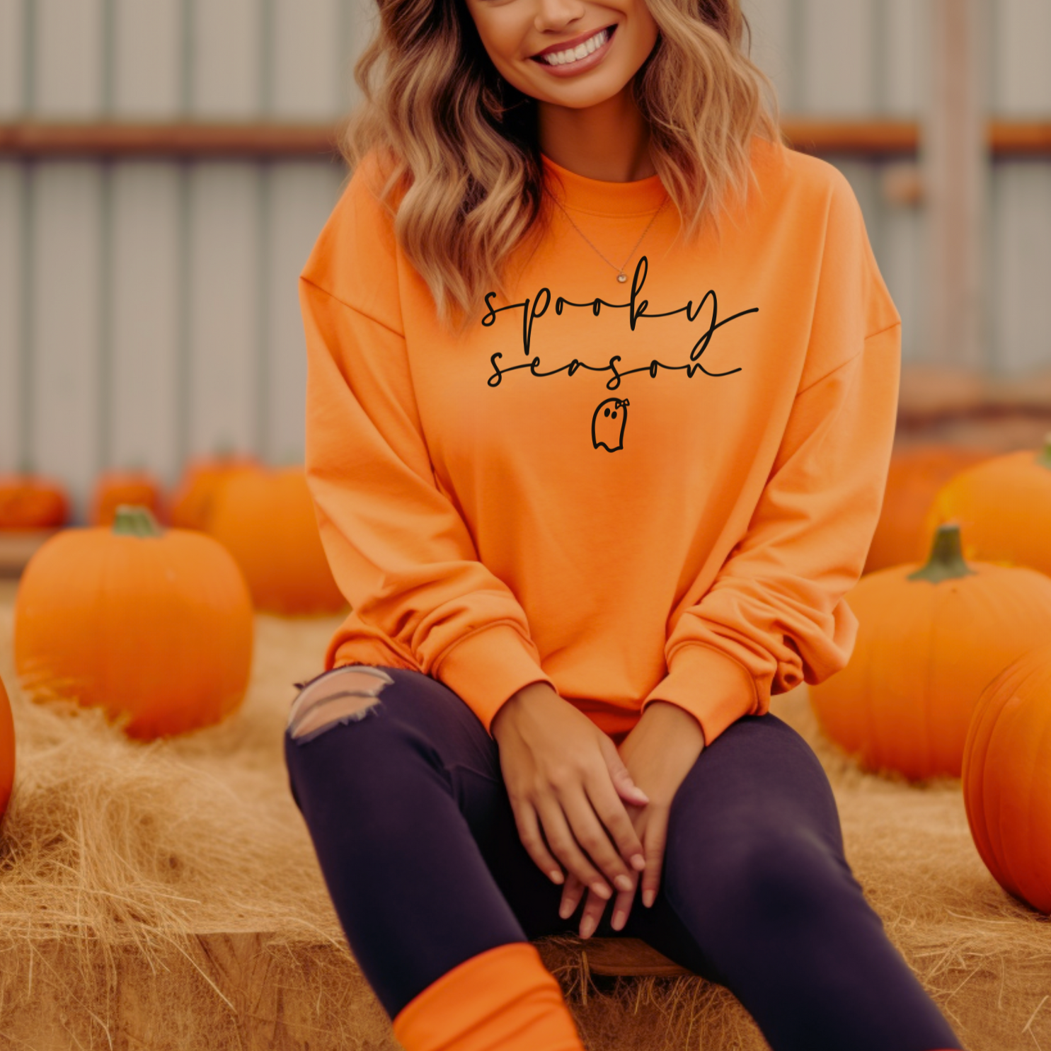 a woman sitting on a hay bale with pumpkins in the background