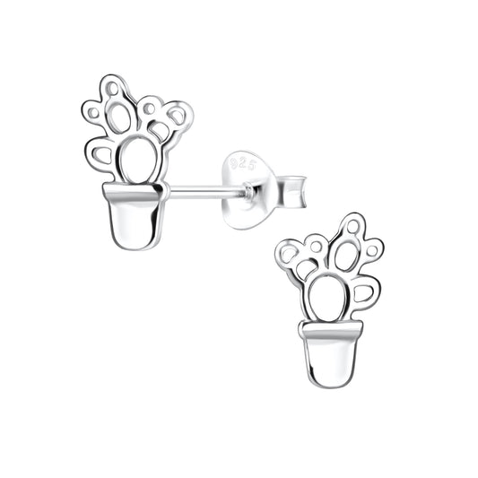 a pair of silver earrings with a flower design