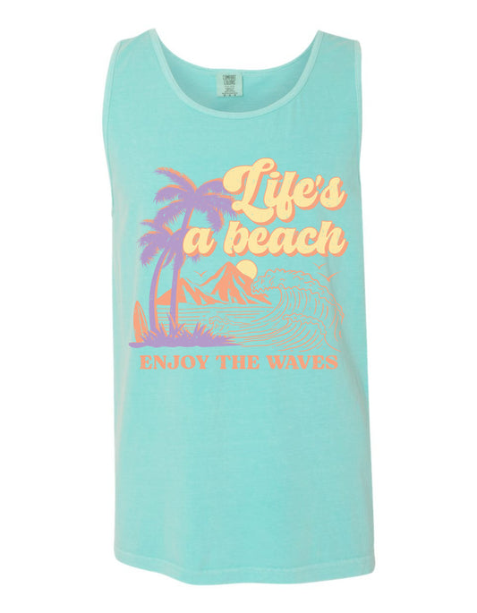 A turquoise tank top with a graphic design depicting palm trees, mountains, and waves, along with the text "Life's a beach, Enjoy the waves" printed on it.