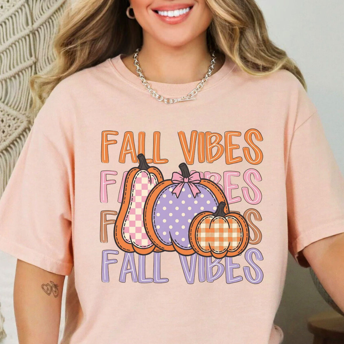 Fall Vibes lettering with checkered, polka-dot and gingham pumpkins on Peachy T-shirt