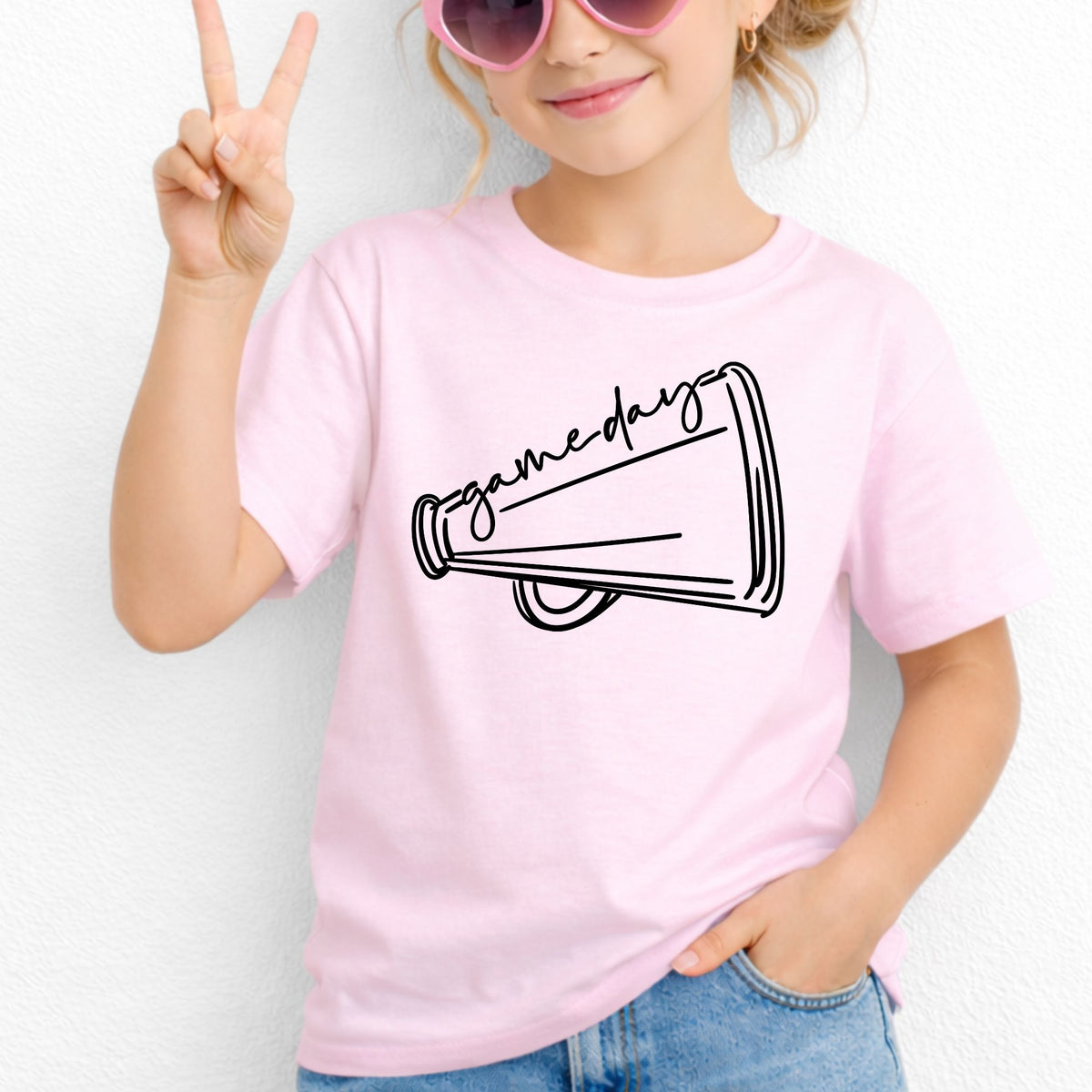 Girl wearing Light Pink Game Day Megaphone Gildan 5000B youth tee