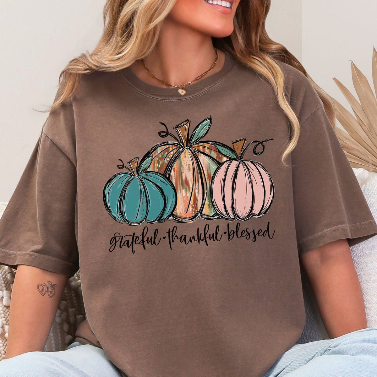 Three painted pumpkins with Grateful Thankful Blessed lettering on a Espresso T-shirt
