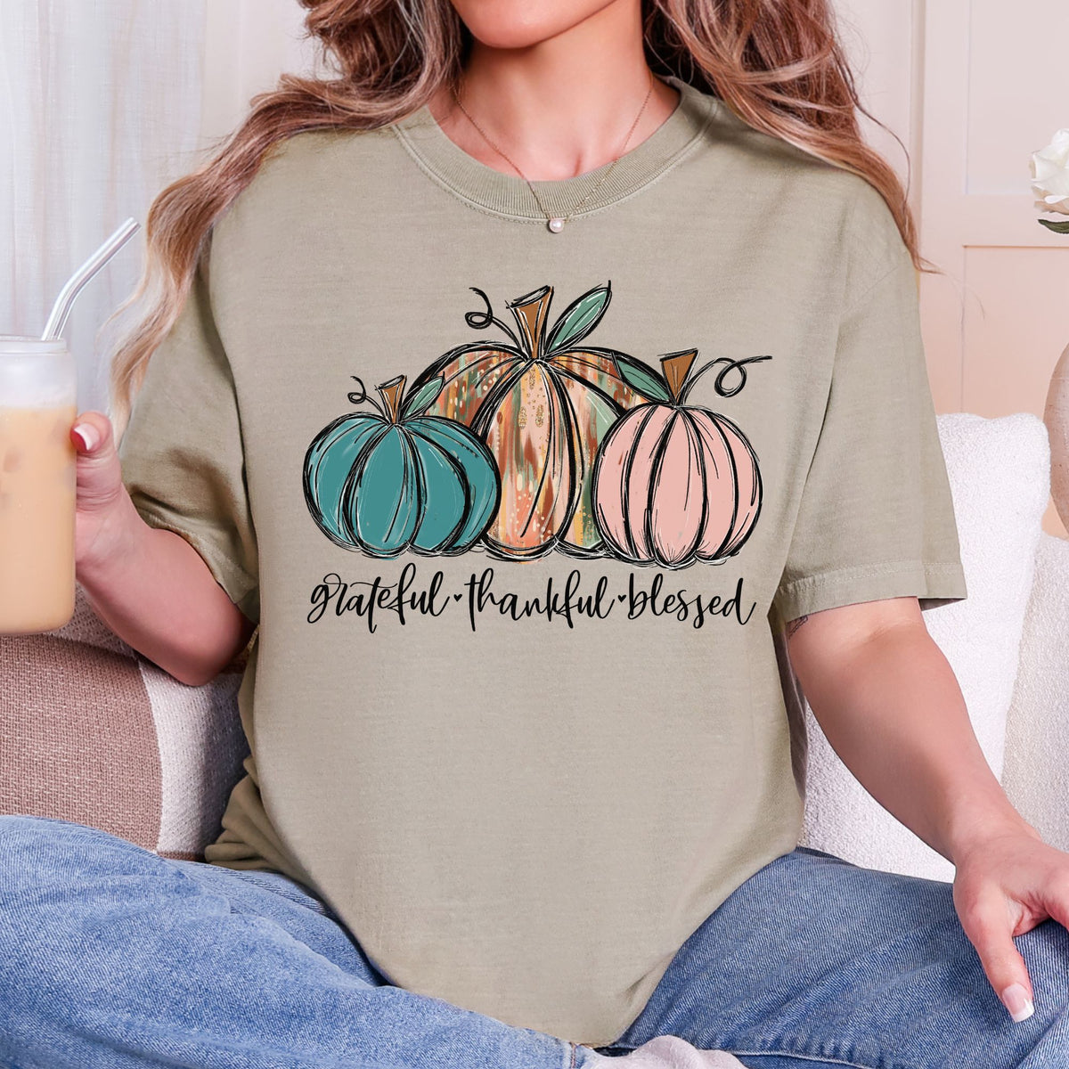 Three painted pumpkins with Grateful Thankful Blessed lettering on a Khaki T-shirt