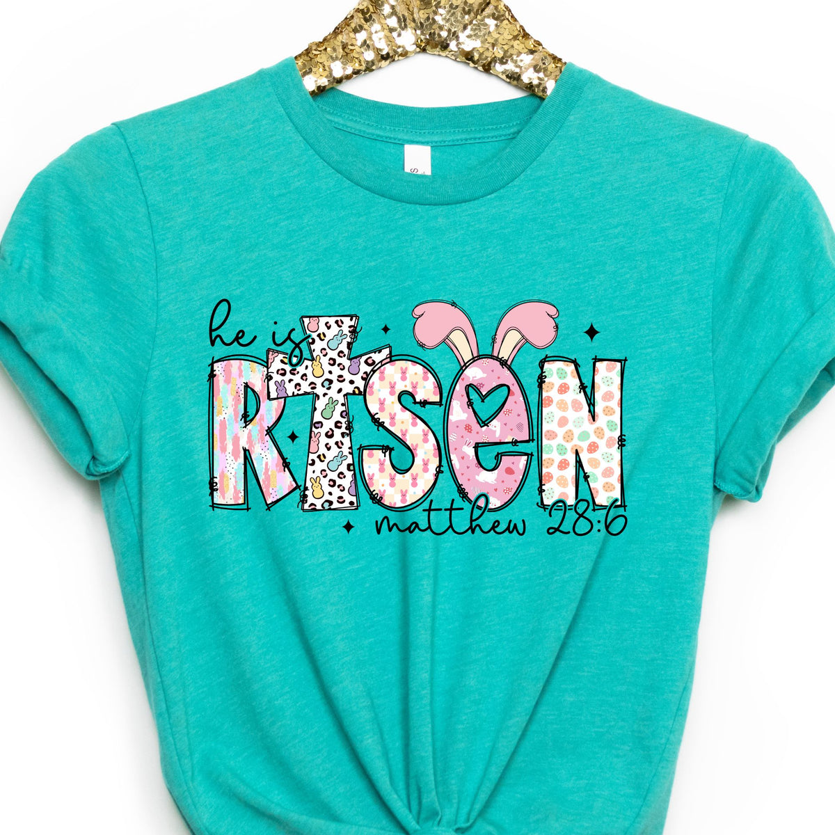 He Is Risen Easter graphic T-shirt in Heather Sea Green