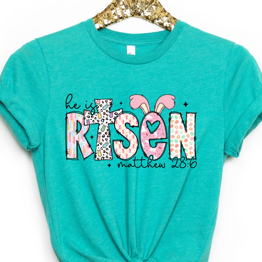 He Is Risen Easter graphic T-shirt in Heather Sea Green