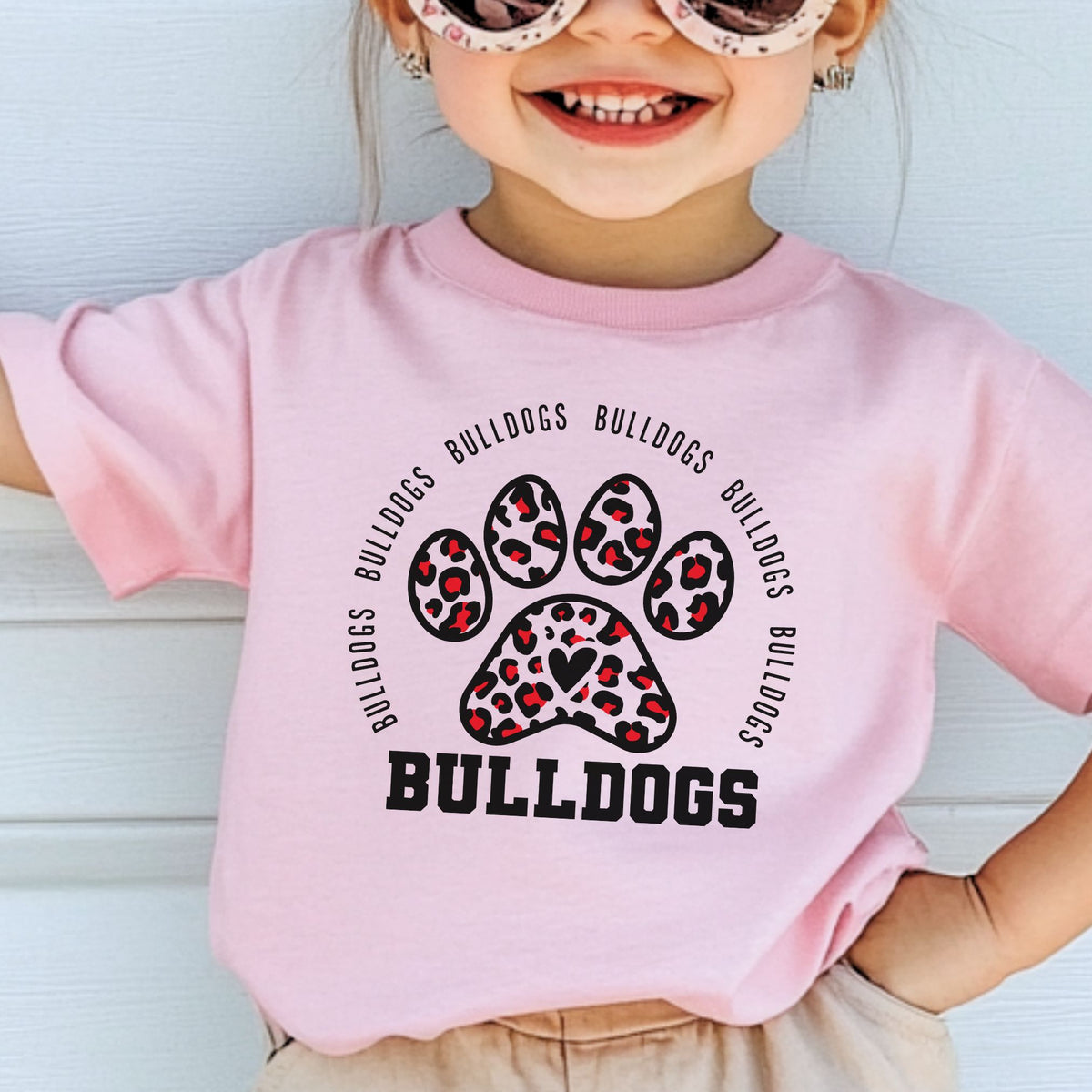 Child wearing Pink leopard paw print Bulldogs toddler tee