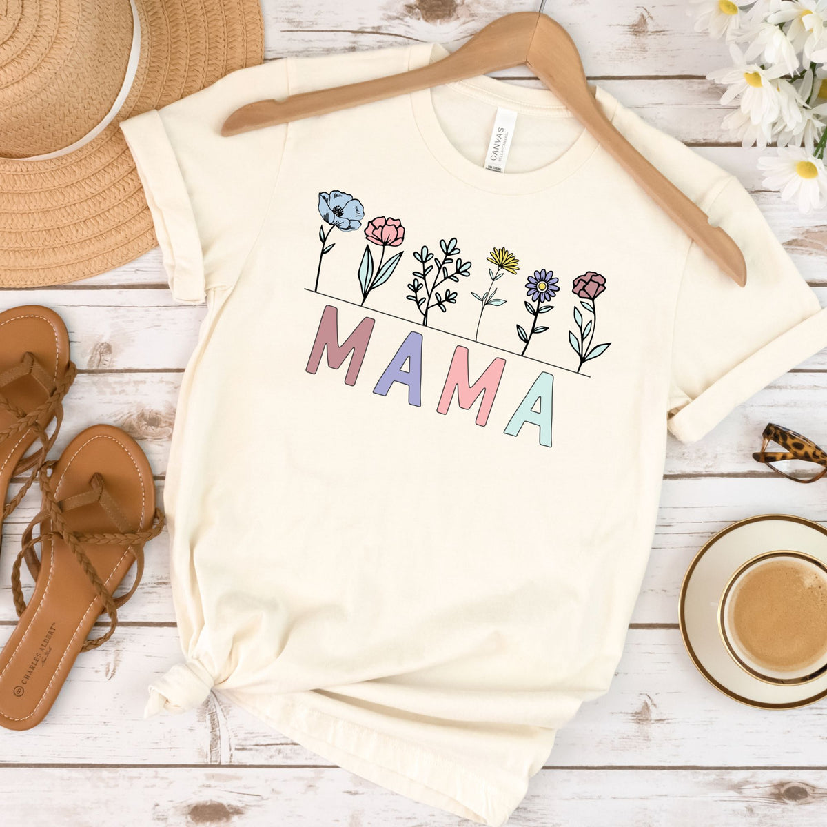 Ivory T-shirt flat lay with pastel MAMA lettering and wildflowers