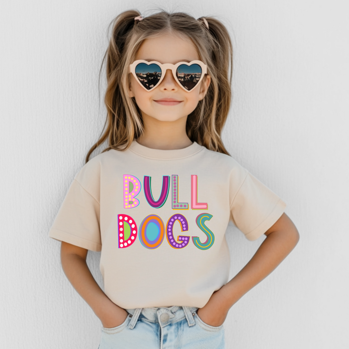 Girl wearing a Natural Bella Canvas 3001Y Marquee Bulldogs youth T-shirt