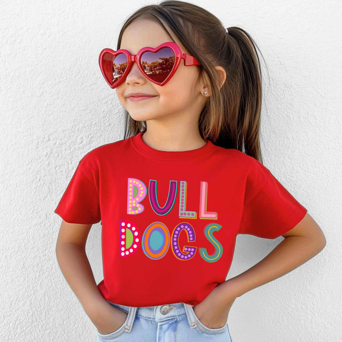 Girl wearing a Red Bella Canvas 3001Y Marquee Bulldogs youth T-shirt