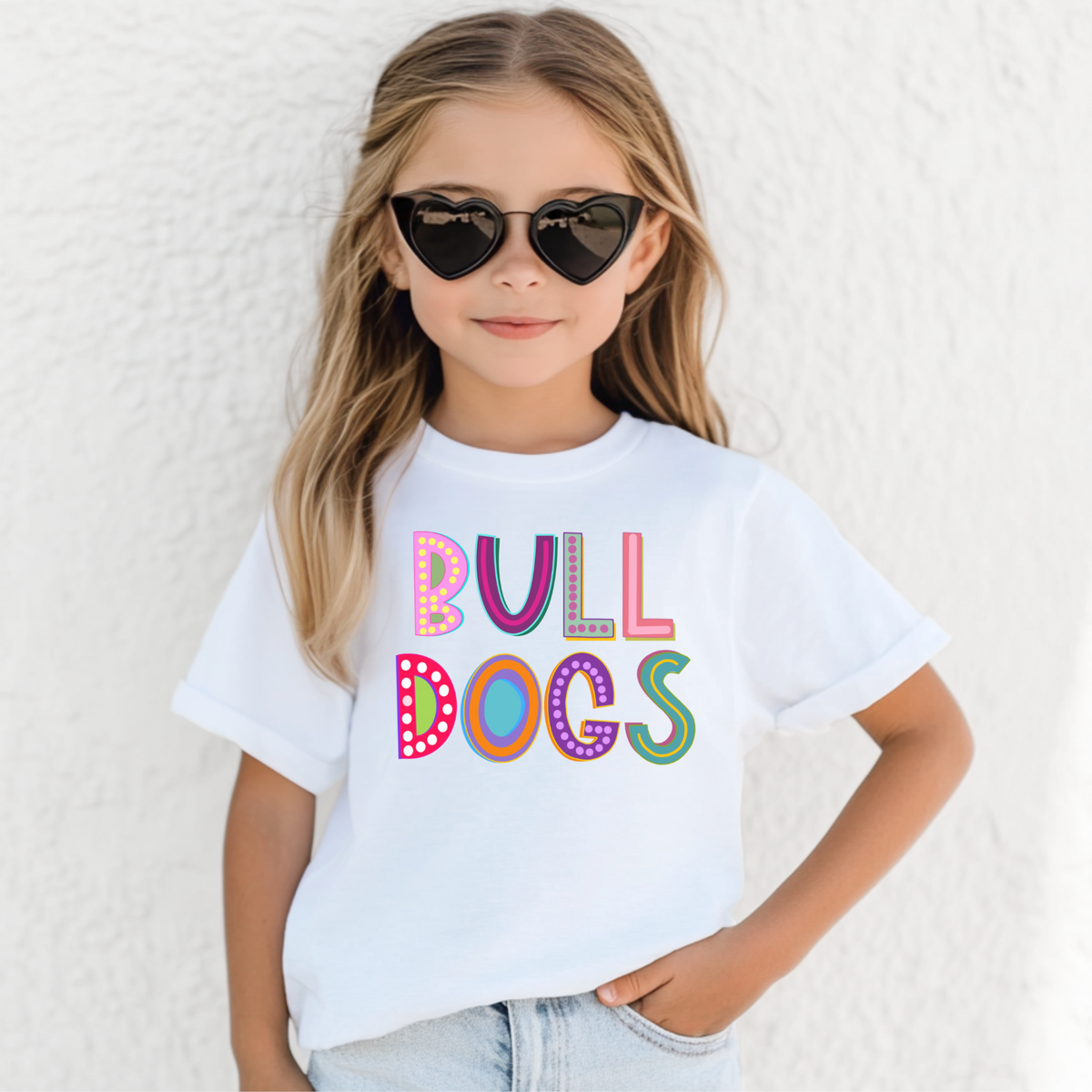 Girl wearing a White Bella Canvas 3001Y Marquee Bulldogs youth T-shirt
