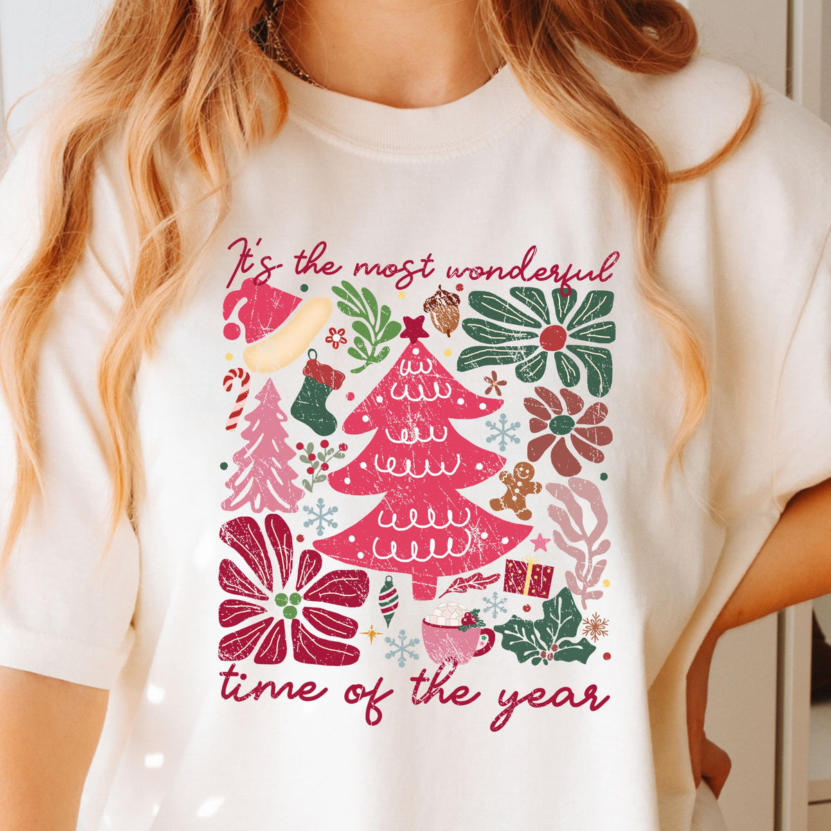 Ivory T-shirt with colorful floral Christmas trees and It's the most wonderful time of the year lettering.