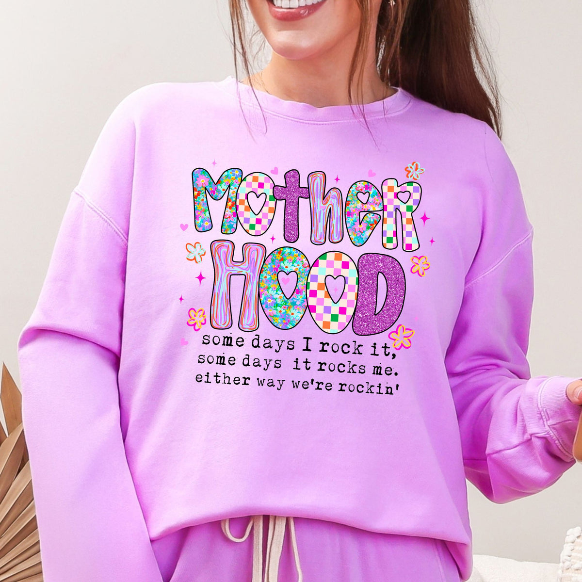 Woman wearing the Neon Violet Mother Hood Comfort Colors 1466 graphic sweatshirt