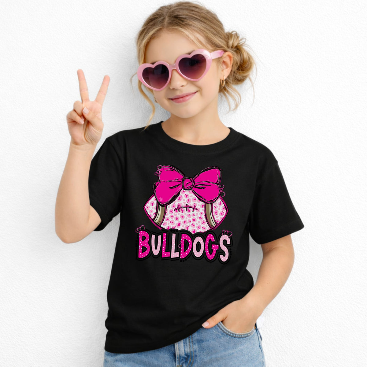 Pink leopard football bow Bulldogs youth T-shirt in Black - Gildan 5000B lifestyle image