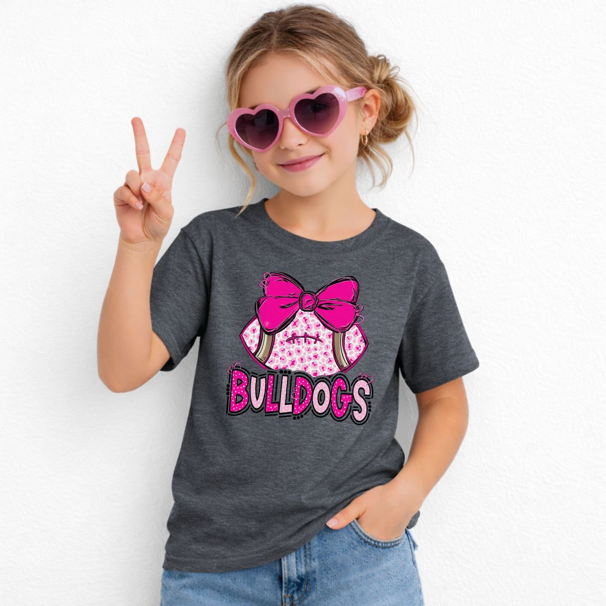 Pink leopard football bow Bulldogs youth T-shirt in Dark Heather - Gildan 5000B lifestyle image