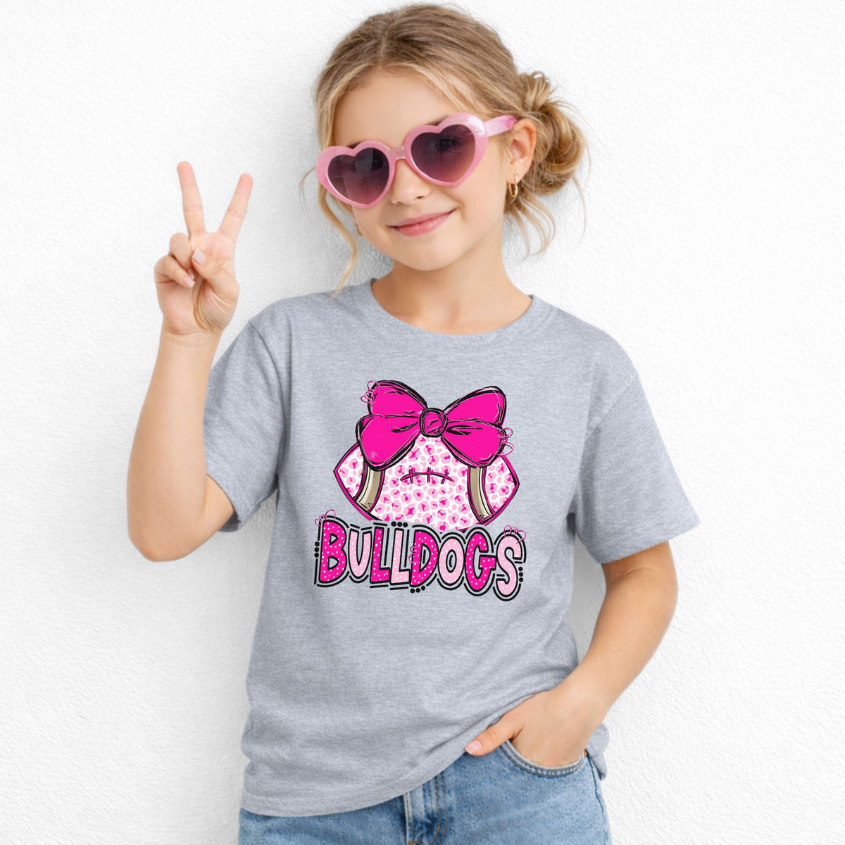 Pink leopard football bow Bulldogs youth T-shirt in Grey - Gildan 5000B lifestyle image
