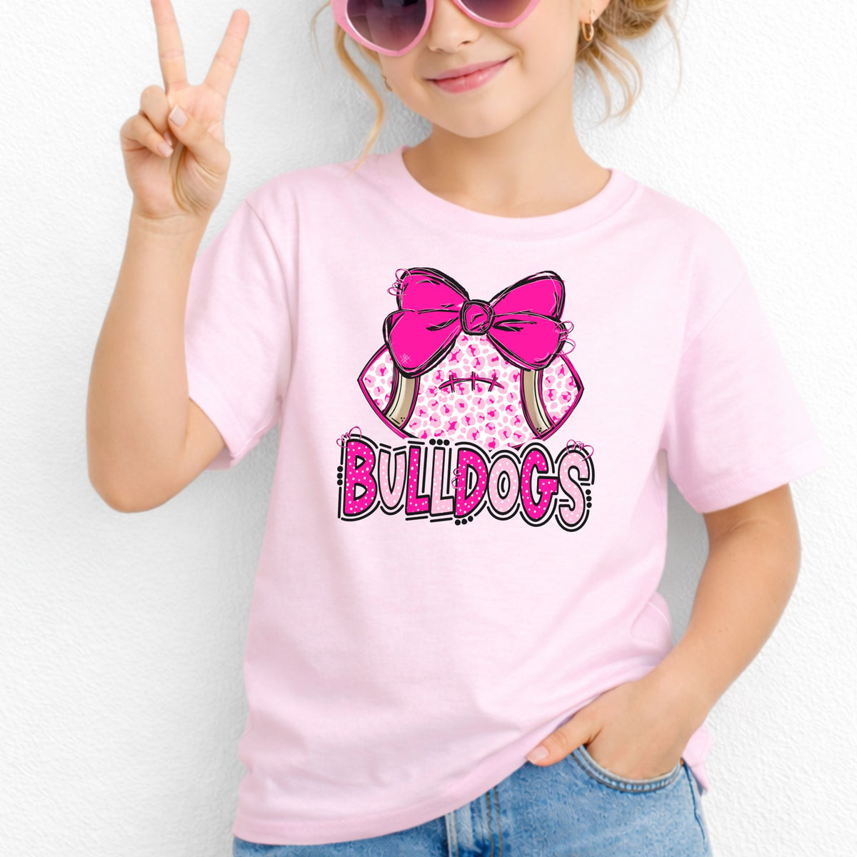 Pink leopard football bow Bulldogs youth T-shirt in Light Pink - Gildan 5000B lifestyle image