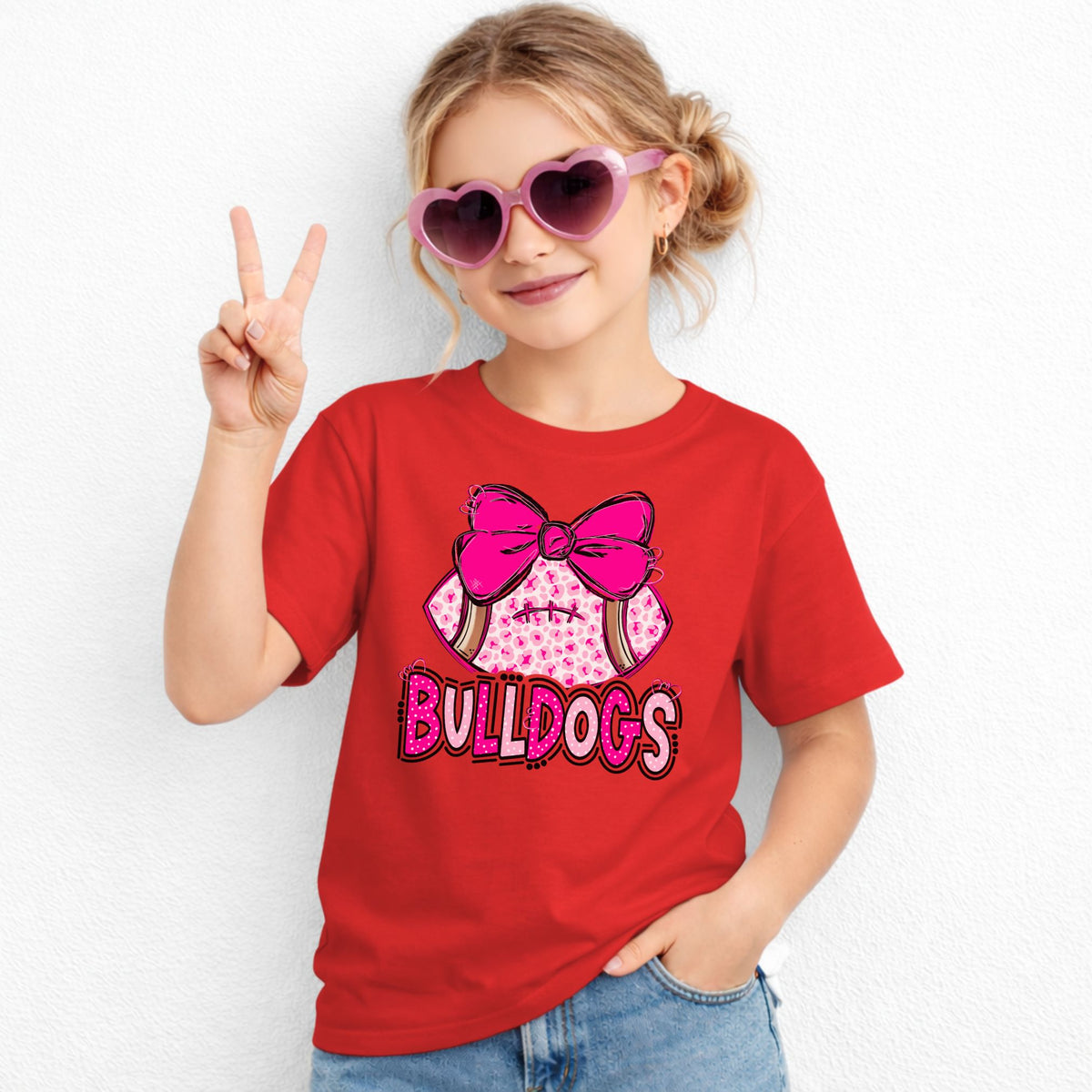 Pink leopard football bow Bulldogs youth T-shirt in Red - Gildan 5000B lifestyle image