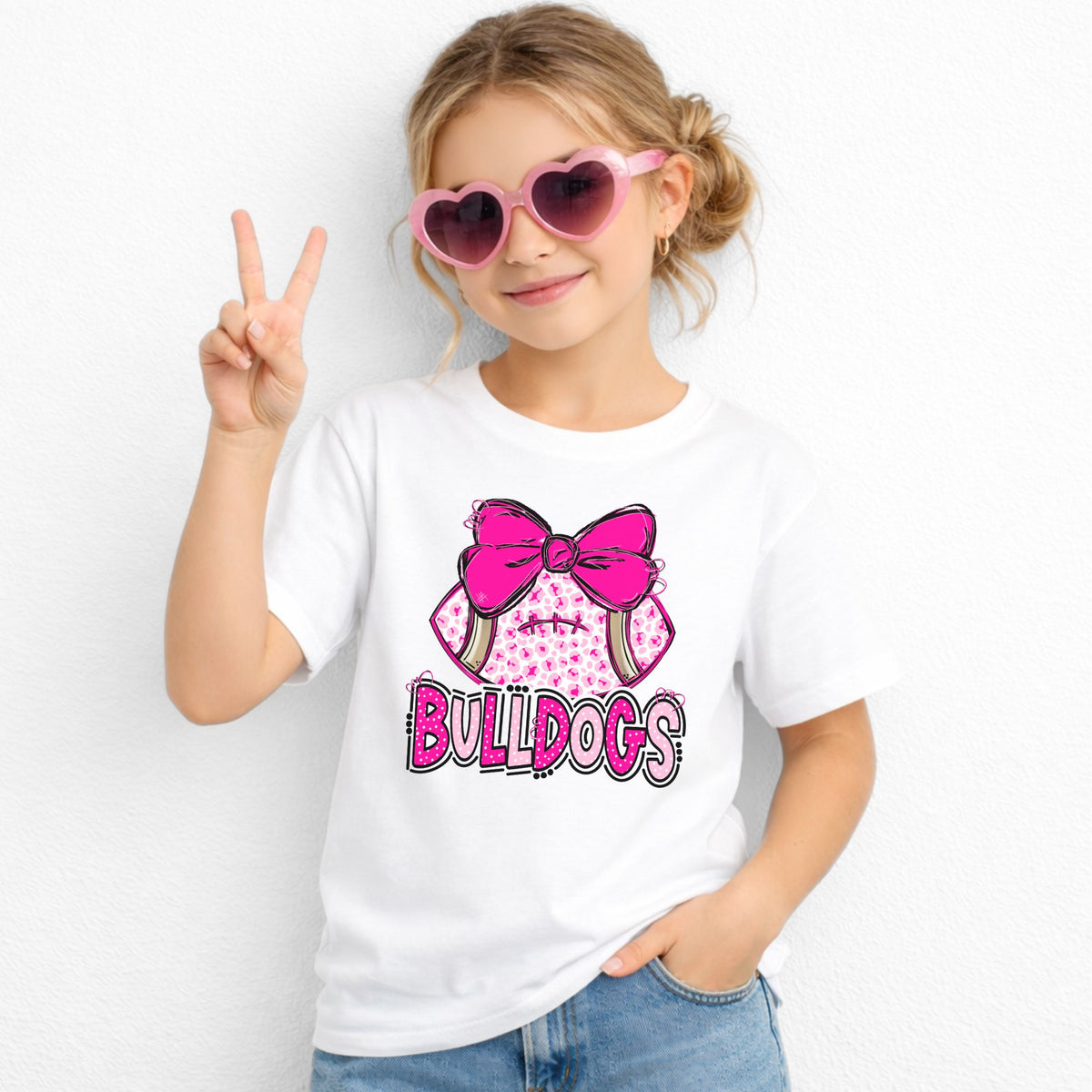 Pink leopard football bow Bulldogs youth T-shirt in White - Gildan 5000B lifestyle image