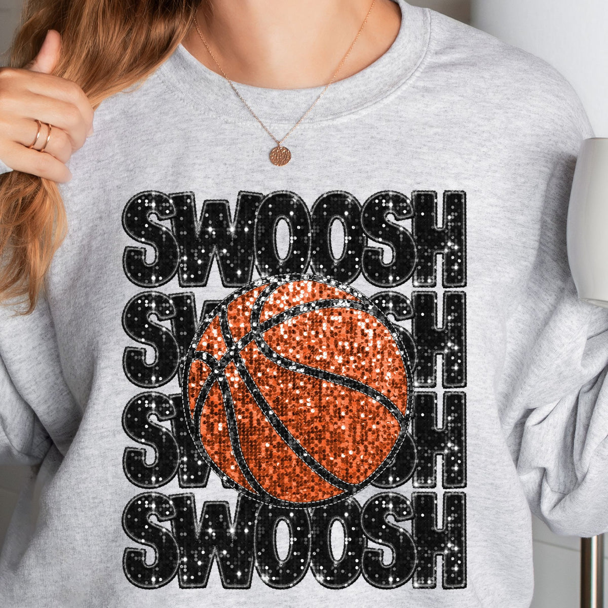 Grey sweatshirt with stacked SWOOSH lettering and orange basketball faux-sequin print