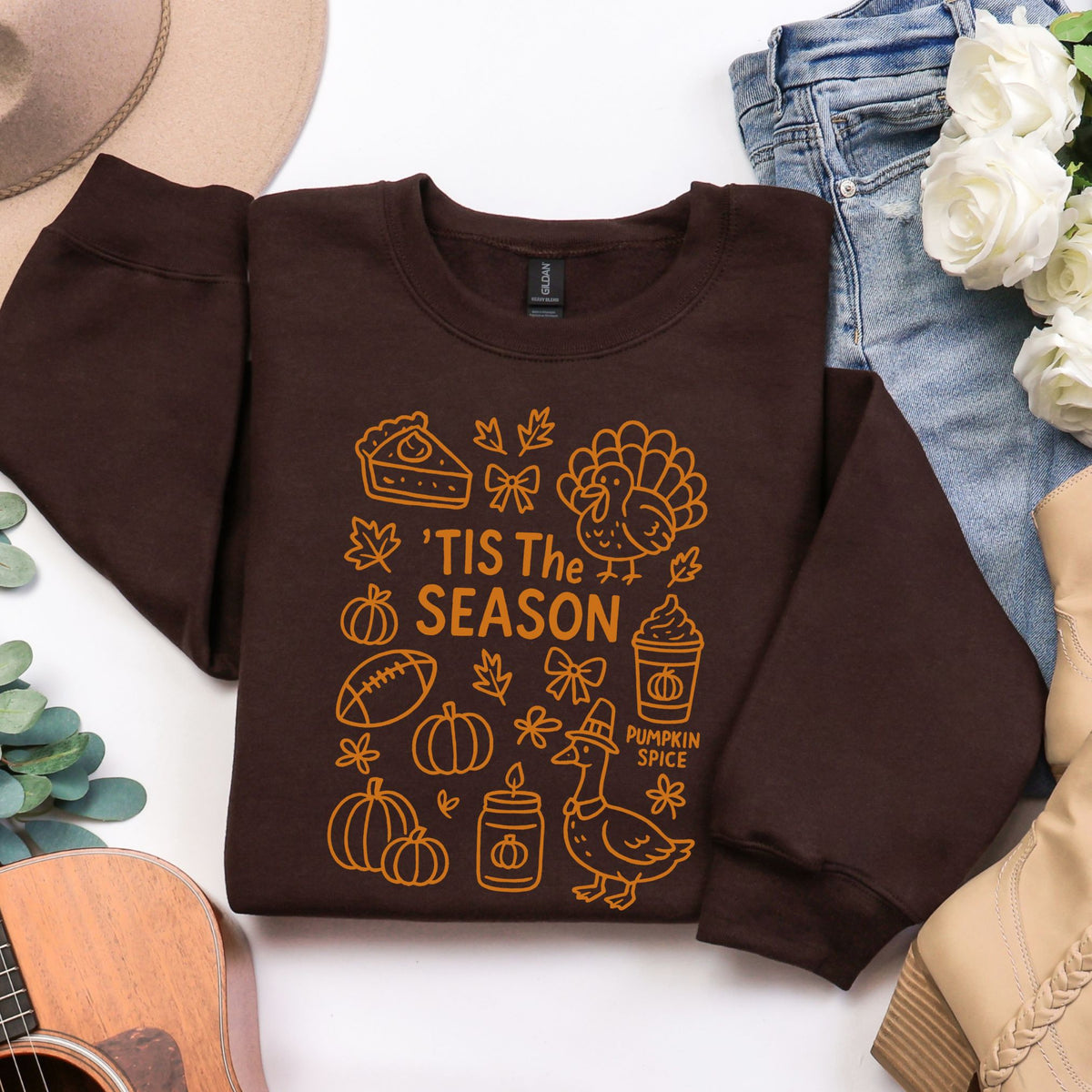 Dark Chocolate ’Tis the Season Thanksgiving sweatshirt with orange doodle artwork in a flat lay